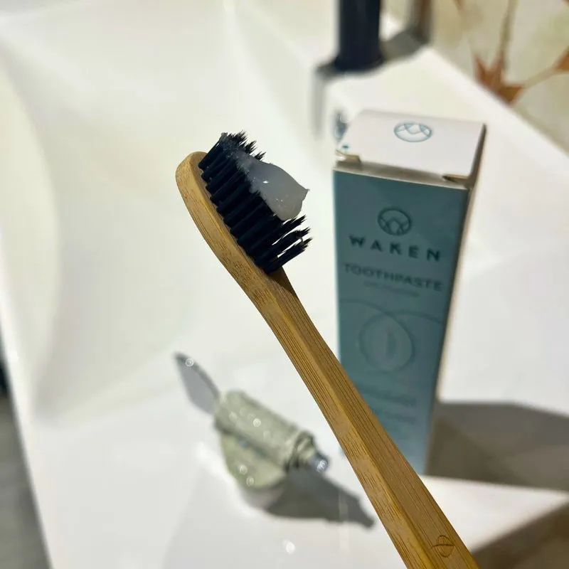 waken toothpaste on a bamboo toothbrush